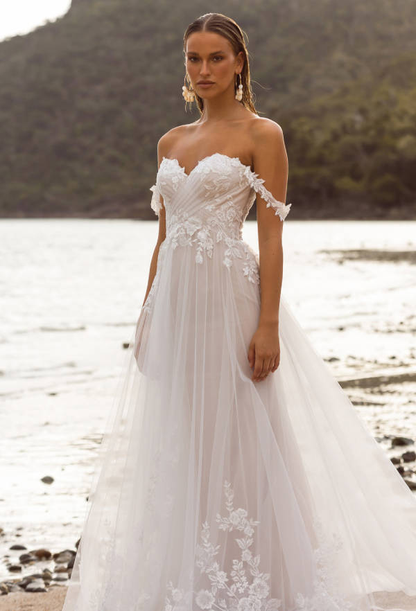 Model wearing a white gown by Madi Lane