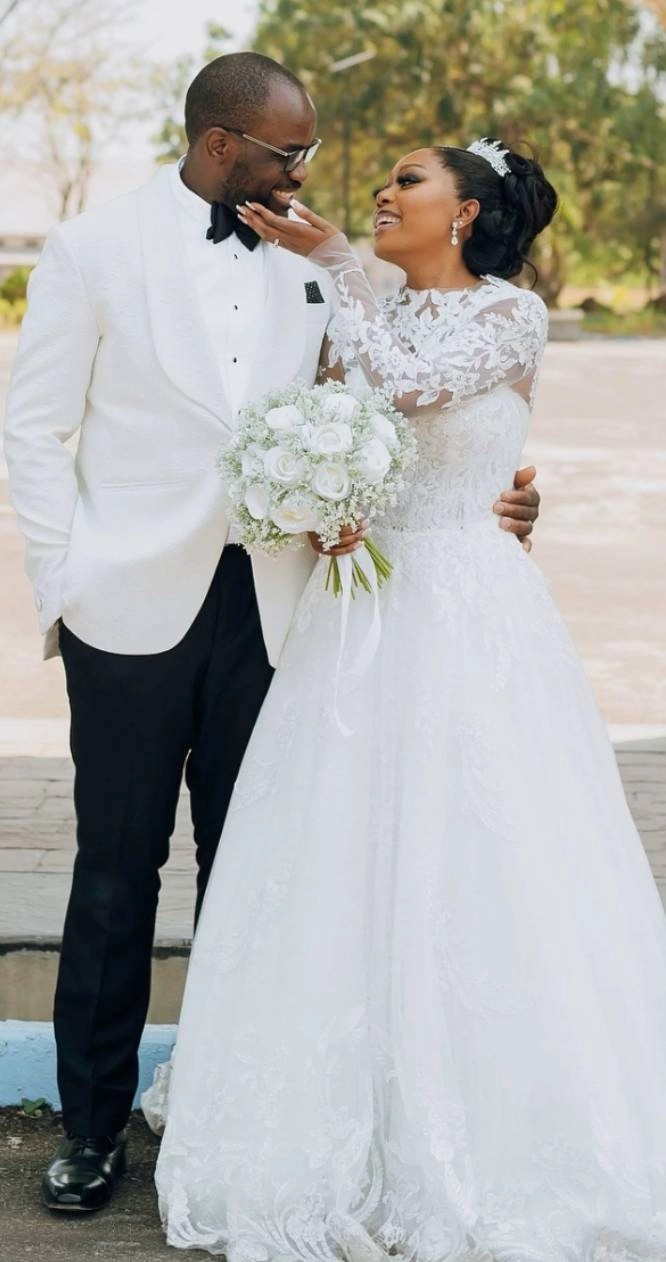 Couple wearing white gown and white suit