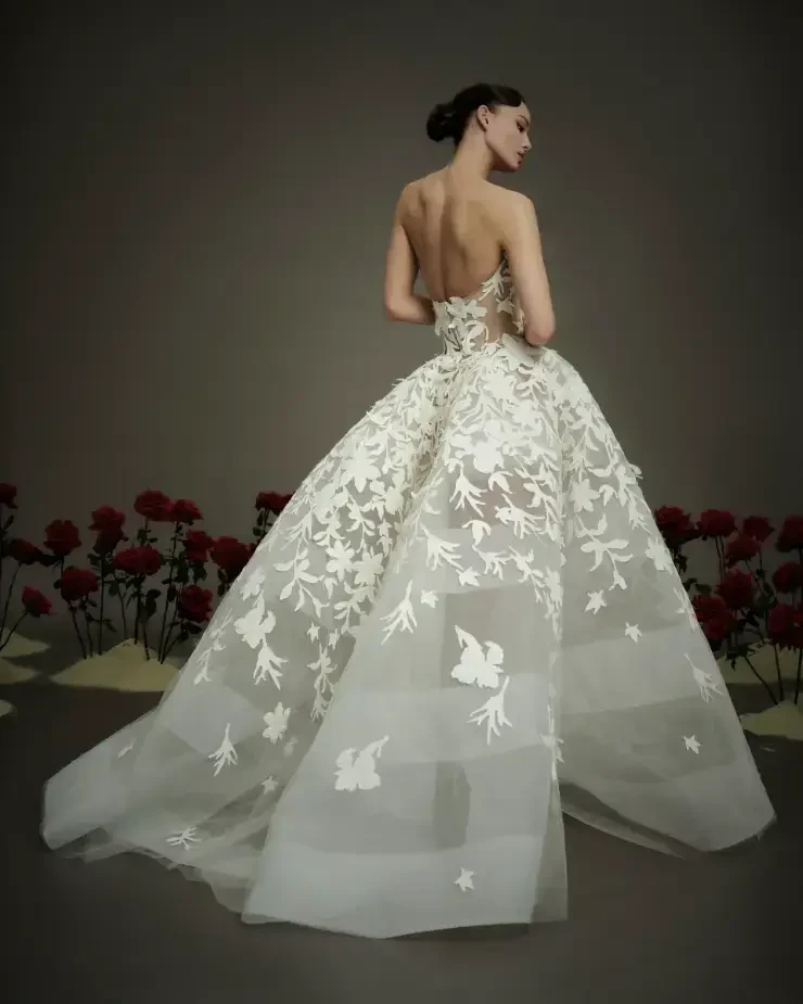 model is wearing a strapless ball gown