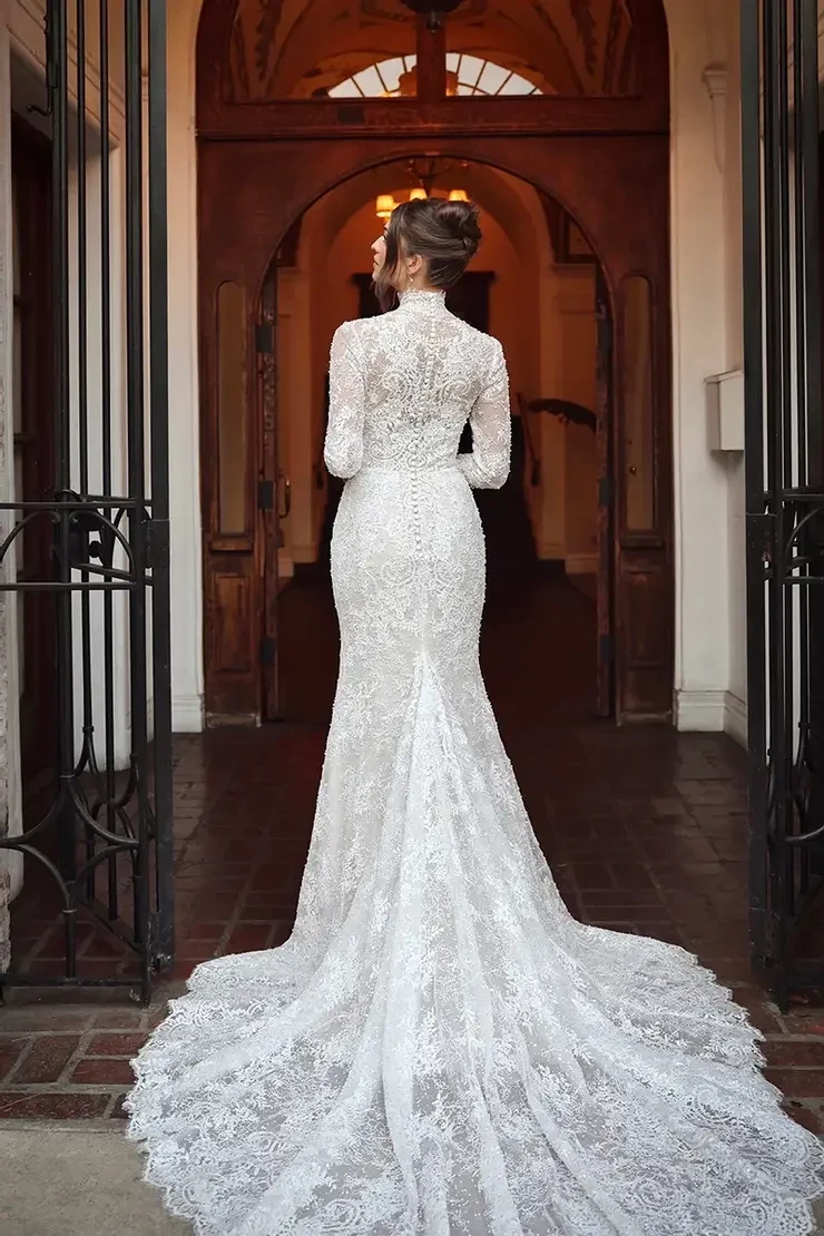 model is wearing a high neck long sleeve lace wedding dress