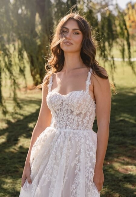 Model wearing a white gown by MADI LANE