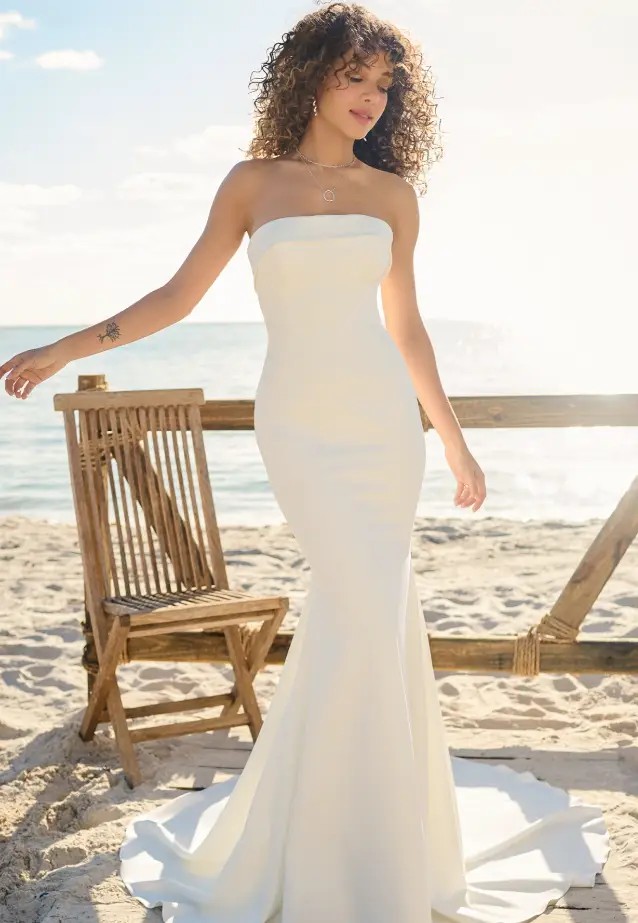Model wearing a white gown by Rebecca Ingram