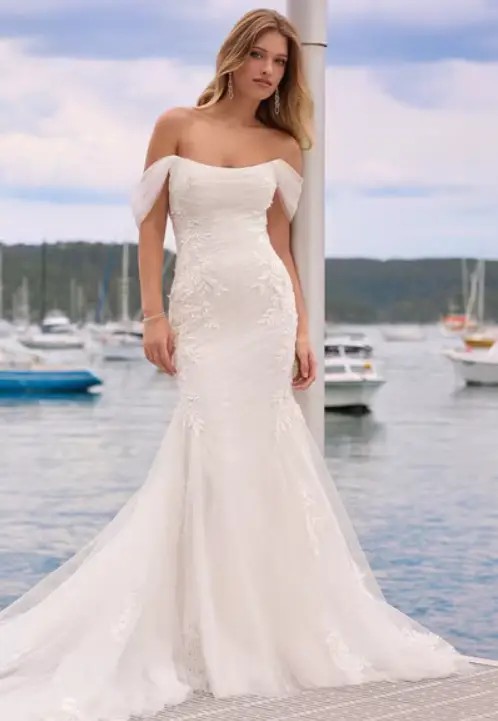 Model wearing a white gown by sophia tolli