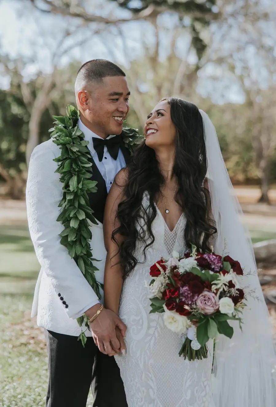 Сouple wearing a white gown and a white suit