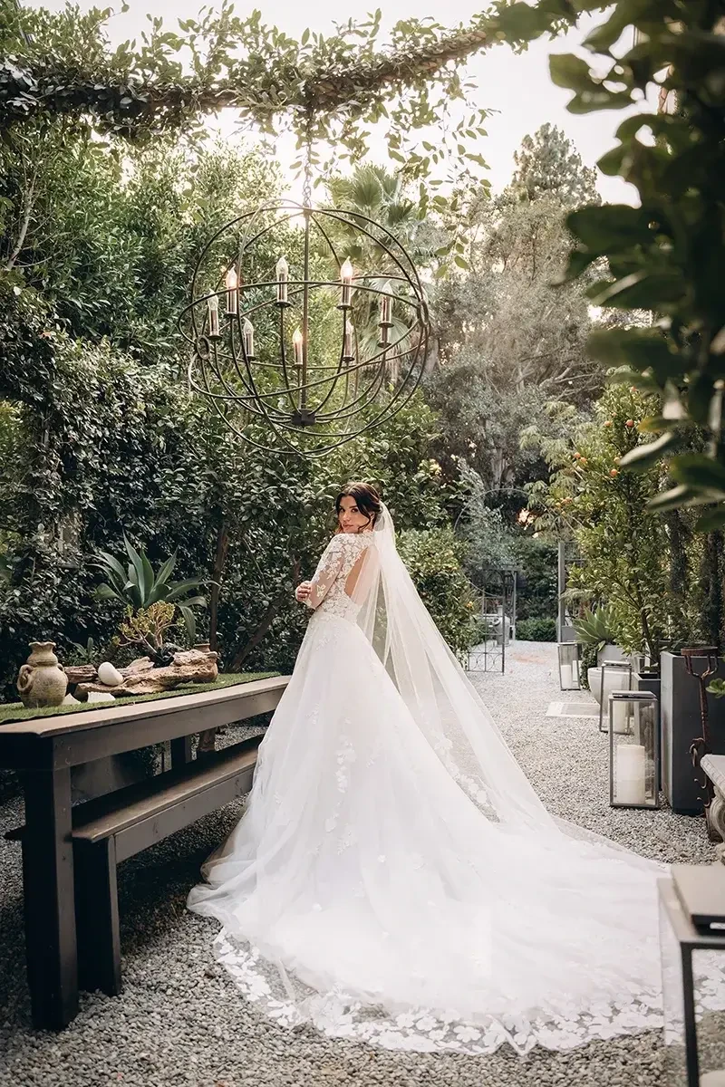 model is wearing a high neck long sleeve a-line wedding dress